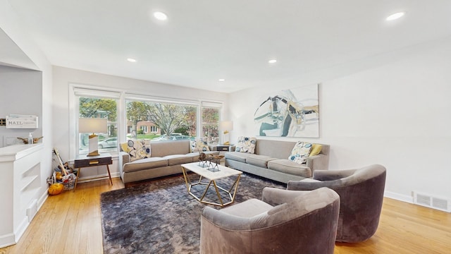 1712 Dobson St, Evanston, IL 60202 - living area with light wood-style floors and recessed lighting