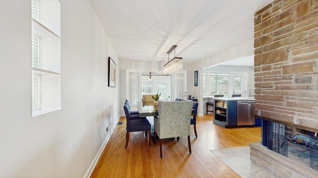 1712 Dobson St, Evanston, IL 60202 - dining room featuring light wood-style floors and a fireplace