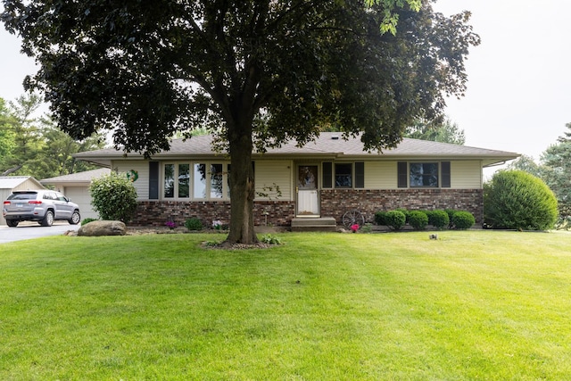 4265 Town Hall Rd, Belvidere, IL 61008 - ranch-style home featuring brick siding and a front lawn