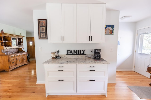 4265 Town Hall Rd, Belvidere, IL 61008 - kitchen with light wood-type flooring, light stone countertops, and white cabinets