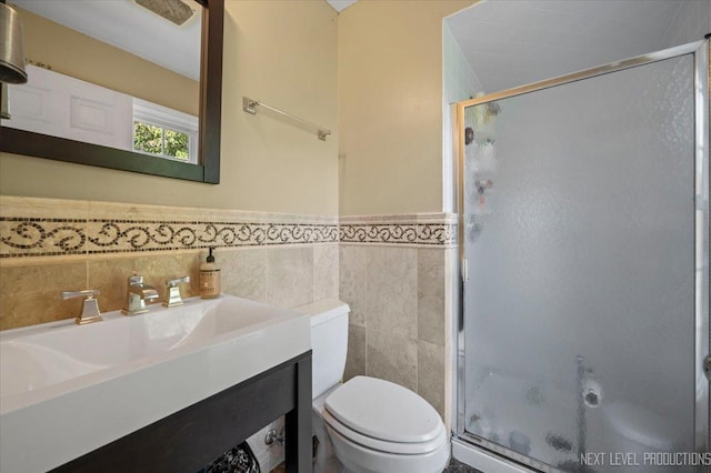 932 S Batavia Ave, Geneva, IL 60134 - full bathroom featuring a shower stall, tile walls, vanity, and wainscoting