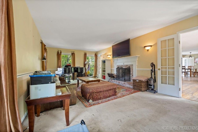 932 S Batavia Ave, Geneva, IL 60134 - living area with a brick fireplace, french doors, and carpet floors