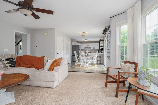 1098 Ironwood Cc Dr, Normal, IL 61761 - living room featuring ceiling fan, stairs, and light carpet