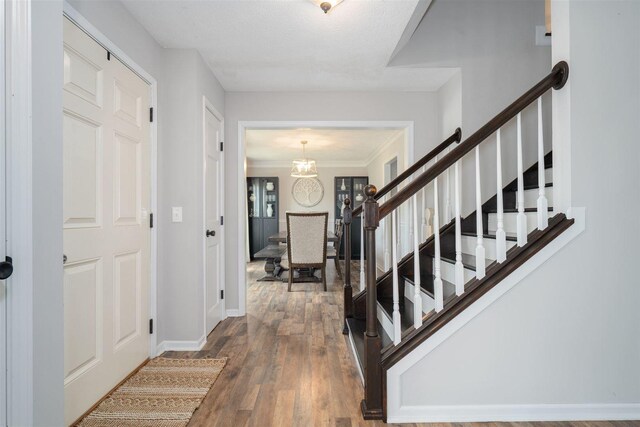 1098 Ironwood Cc Dr, Normal, IL 61761 - foyer with stairway, wood finished floors, crown molding, and a chandelier