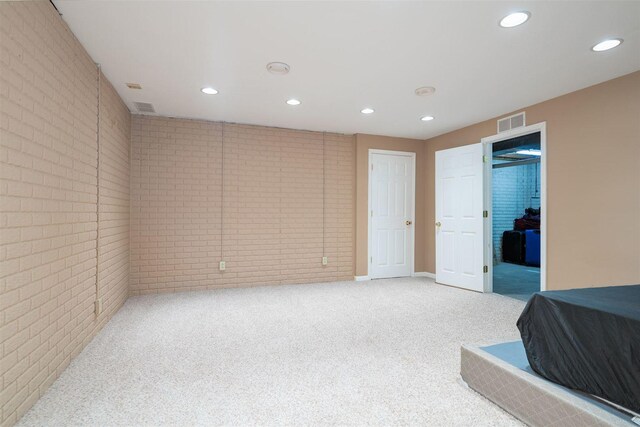 1098 Ironwood Cc Dr, Normal, IL 61761 - bedroom with brick wall, recessed lighting, and light colored carpet