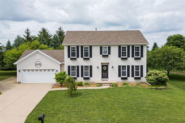 1098 Ironwood Cc Dr, Normal, IL 61761 - colonial home with concrete driveway, a garage, a front lawn, and roof with shingles