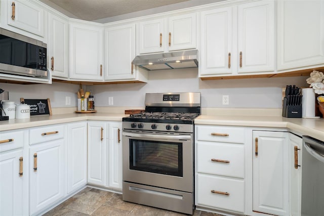 1098 Ironwood Cc Dr, Normal, IL 61761 - kitchen featuring appliances with stainless steel finishes, under cabinet range hood, white cabinetry, and light countertops