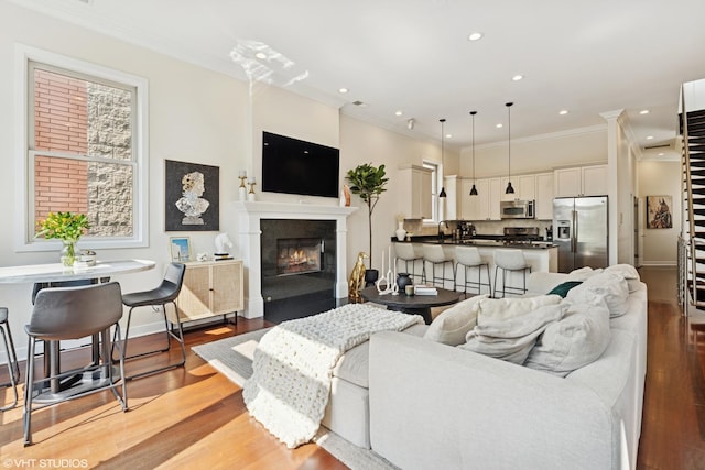 1051 N Hermitage Ave Unit 3, Chicago, IL 60622 - living room with light wood-style floors, ornamental molding, a fireplace with flush hearth, and recessed lighting