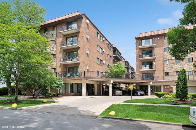 2333 N Neva Ave Unit 114C, Chicago, IL 60707 - view of apartment building / complex featuring covered parking