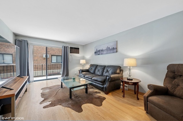 2333 N Neva Ave Unit 114C, Chicago, IL 60707 - living room with light wood-style flooring and a wall unit AC