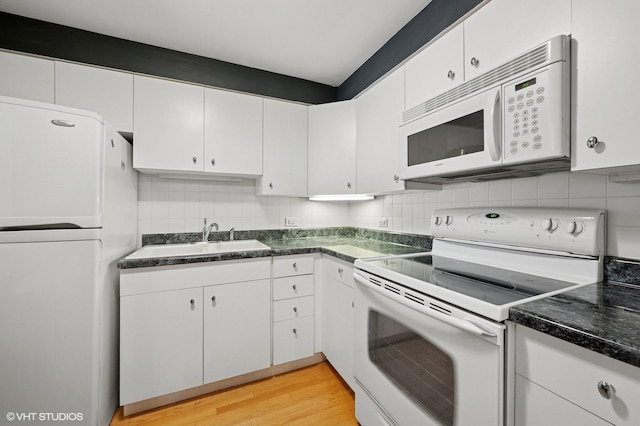 2333 N Neva Ave Unit 114C, Chicago, IL 60707 - kitchen with white appliances, white cabinetry, decorative backsplash, and dark countertops