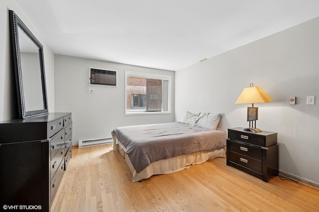 2333 N Neva Ave Unit 114C, Chicago, IL 60707 - bedroom featuring a baseboard heating unit, light wood-style flooring, and a wall mounted air conditioner