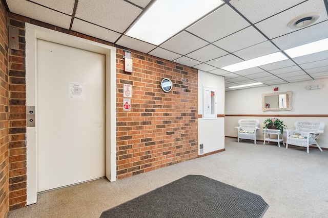 1420 Woodbridge Rd Unit 3C, Joliet, IL 60436 - lobby featuring a drop ceiling and brick wall