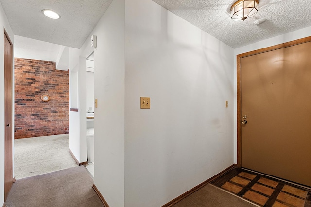 1420 Woodbridge Rd Unit 3C, Joliet, IL 60436 - hall featuring a textured ceiling, brick wall, and carpet flooring