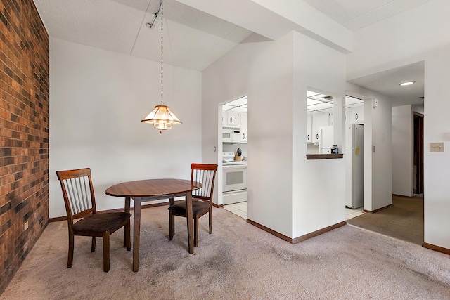 1420 Woodbridge Rd Unit 3C, Joliet, IL 60436 - carpeted dining space with brick wall, a chandelier, and high vaulted ceiling