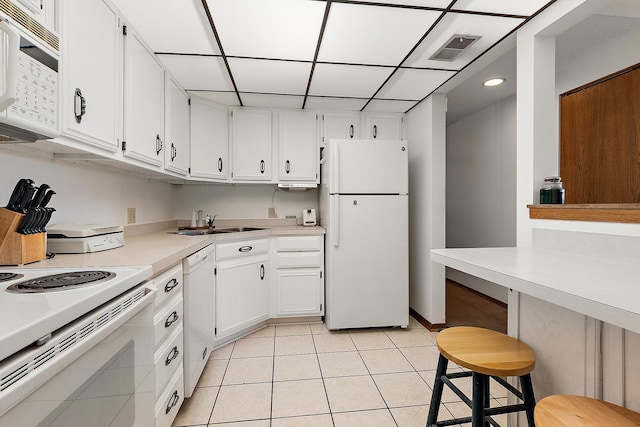 1420 Woodbridge Rd Unit 3C, Joliet, IL 60436 - kitchen with white appliances, light countertops, light tile patterned floors, white cabinetry, and a drop ceiling