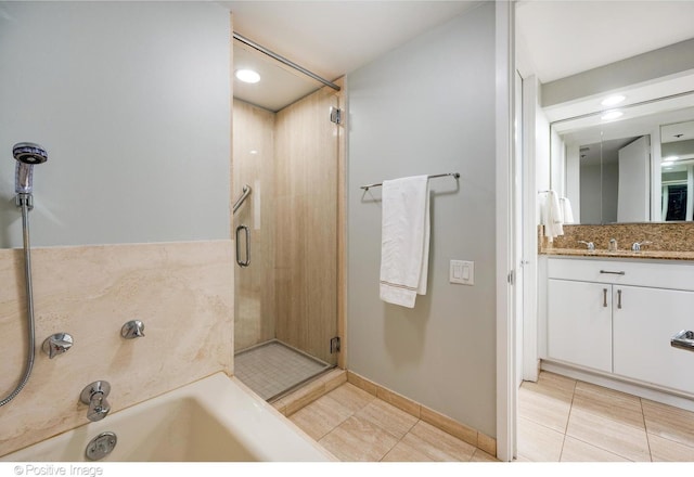 950 N Michigan Ave Unit 2901, Chicago, IL 60611 - full bath with tile patterned floors, vanity, a bath, a shower stall, and backsplash