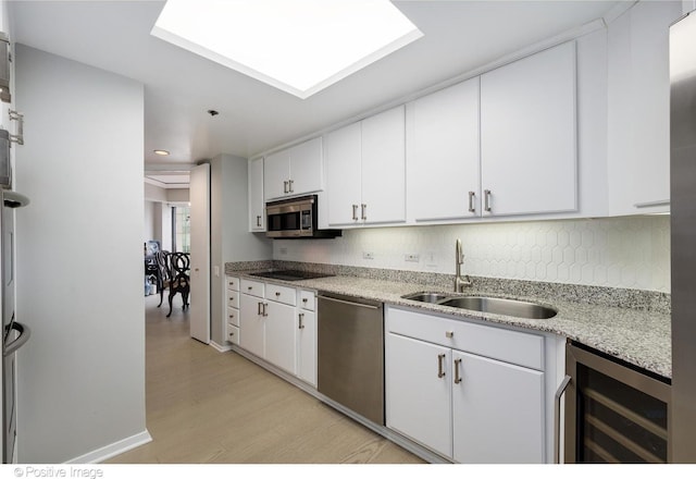 950 N Michigan Ave Unit 2901, Chicago, IL 60611 - kitchen with beverage cooler, appliances with stainless steel finishes, light wood-type flooring, white cabinetry, and tasteful backsplash