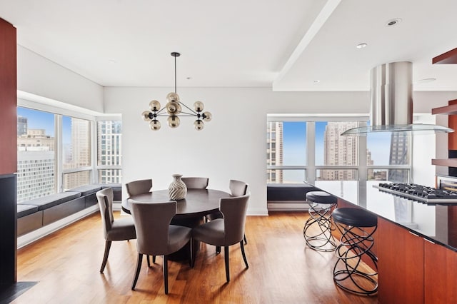 800 N Michigan Ave Unit 3103, Chicago, IL 60611 - dining room with a view of city, a chandelier, and light wood-type flooring