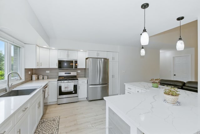 10935 Barbs Way, Orland Park, IL 60467 - kitchen with stainless steel appliances, light wood-type flooring, decorative backsplash, white cabinetry, and lofted ceiling