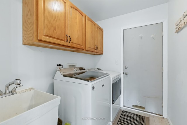 10935 Barbs Way, Orland Park, IL 60467 - laundry area with separate washer and dryer, cabinet space, and light wood finished floors