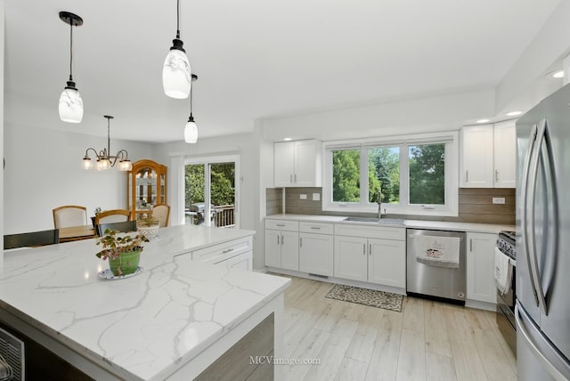 10935 Barbs Way, Orland Park, IL 60467 - kitchen featuring stainless steel appliances, backsplash, white cabinetry, a chandelier, and a kitchen island
