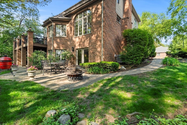 1396 Notre Dame Dr, Lemont, IL 60439 - back of property with an outdoor fire pit, a yard, a patio area, and brick siding