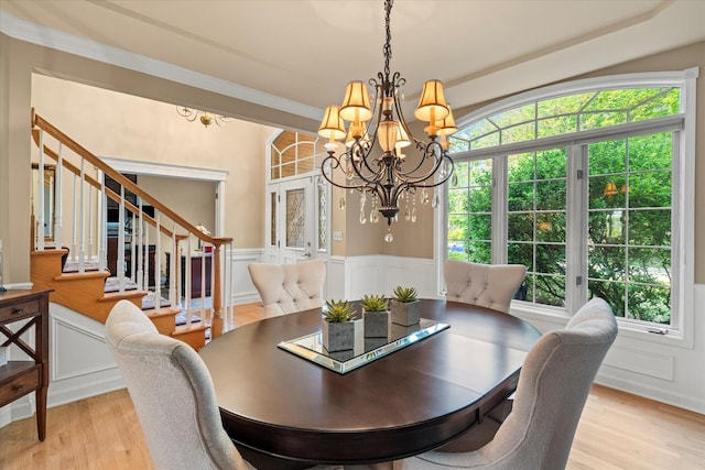 1396 Notre Dame Dr, Lemont, IL 60439 - dining space with a chandelier, stairway, light wood-style floors, a decorative wall, and a wainscoted wall