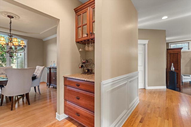 1396 Notre Dame Dr, Lemont, IL 60439 - kitchen featuring light wood-style floors, a chandelier, glass insert cabinets, decorative light fixtures, and brown cabinetry