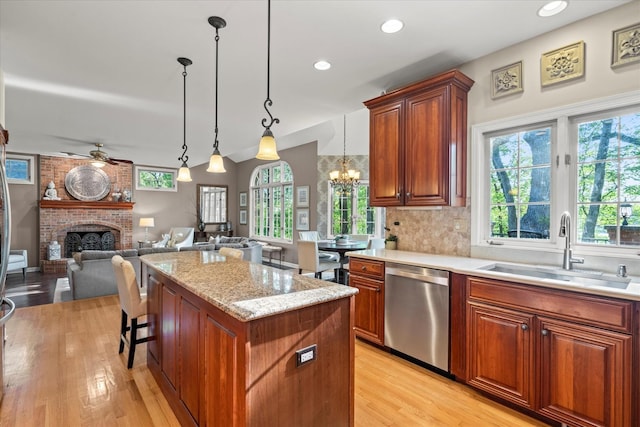 1396 Notre Dame Dr, Lemont, IL 60439 - kitchen with dishwasher, ceiling fan, a fireplace, light wood-style floors, and a chandelier