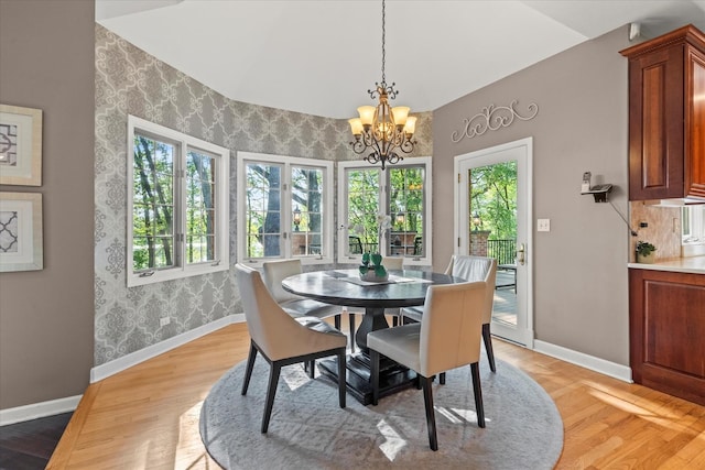 1396 Notre Dame Dr, Lemont, IL 60439 - dining room featuring wallpapered walls, a chandelier, light wood-style floors, and high vaulted ceiling
