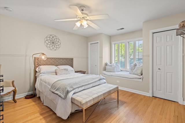 1396 Notre Dame Dr, Lemont, IL 60439 - bedroom featuring multiple closets, light wood-style flooring, and a ceiling fan