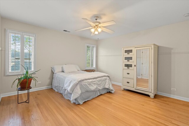 1396 Notre Dame Dr, Lemont, IL 60439 - bedroom with multiple windows, light wood-style flooring, and ceiling fan