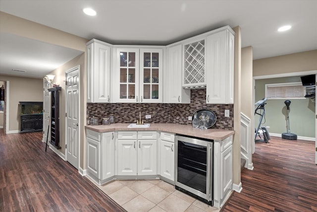 1396 Notre Dame Dr, Lemont, IL 60439 - kitchen with wine cooler, white cabinets, glass insert cabinets, light countertops, and recessed lighting
