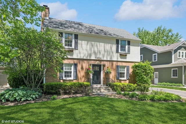 2236 Birchwood Ave, Wilmette, IL 60091 - view of front facade with a chimney, a front lawn, and brick siding
