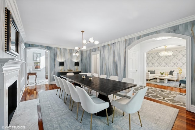 2236 Birchwood Ave, Wilmette, IL 60091 - dining room with wallpapered walls, arched walkways, a chandelier, crown molding, and wainscoting