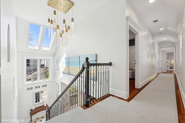 2236 Birchwood Ave, Wilmette, IL 60091 - corridor with an upstairs landing, wood finished floors, recessed lighting, high vaulted ceiling, and a skylight