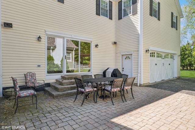 2236 Birchwood Ave, Wilmette, IL 60091 - view of patio with an attached garage, asphalt driveway, and area for grilling