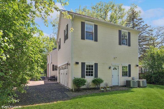2236 Birchwood Ave, Wilmette, IL 60091 - rear view of house featuring an attached garage, a lawn, and driveway
