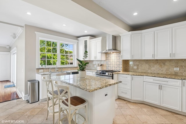 2236 Birchwood Ave, Wilmette, IL 60091 - kitchen with wall chimney exhaust hood, ornamental molding, a kitchen island, white cabinets, and recessed lighting