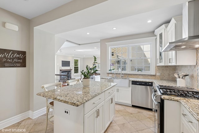 2236 Birchwood Ave, Wilmette, IL 60091 - kitchen with appliances with stainless steel finishes, wall chimney range hood, white cabinets, backsplash, and recessed lighting