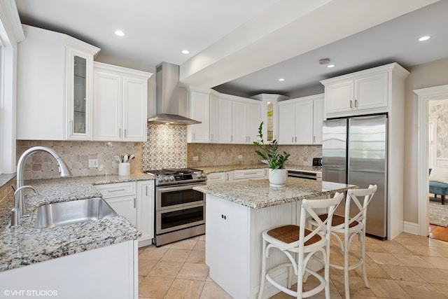 2236 Birchwood Ave, Wilmette, IL 60091 - kitchen with stainless steel appliances, wall chimney range hood, white cabinetry, a center island, and backsplash