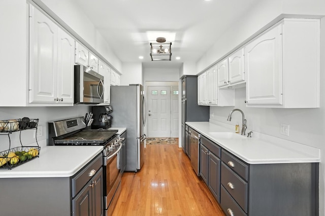 7855 Silver Ct, Orland Park, IL 60462 - kitchen featuring stainless steel appliances, white cabinets, gray cabinetry, light wood-type flooring, and recessed lighting