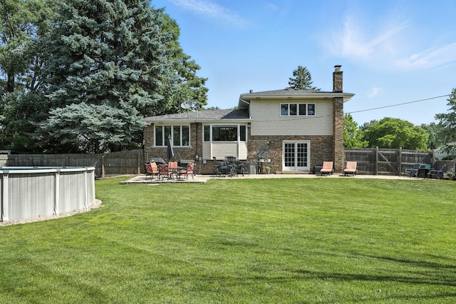 7855 Silver Ct, Orland Park, IL 60462 - rear view of property featuring a chimney, a fenced backyard, brick siding, and a patio area
