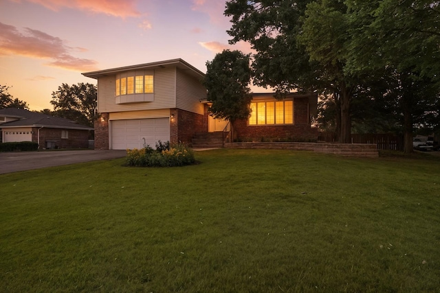 7855 Silver Ct, Orland Park, IL 60462 - split level home with brick siding, driveway, a garage, and a yard