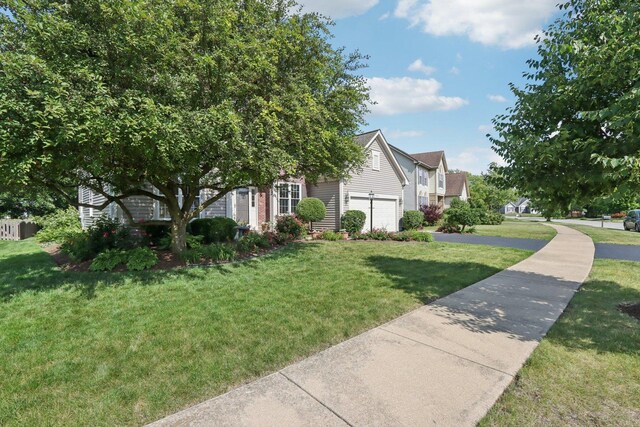 1128 Teasel Ln, Naperville, IL 60564 - view of front facade featuring a front lawn, driveway, and an attached garage