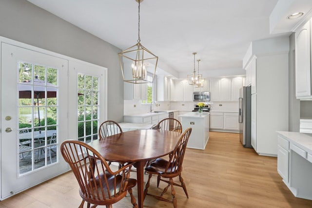 1128 Teasel Ln, Naperville, IL 60564 - dining space with a chandelier and light wood-style floors