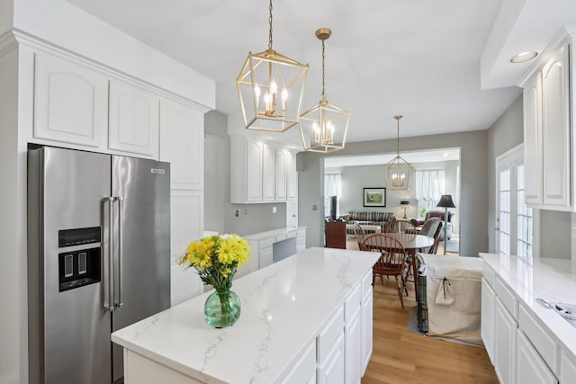 1128 Teasel Ln, Naperville, IL 60564 - kitchen featuring high end refrigerator, open floor plan, a chandelier, and white cabinets