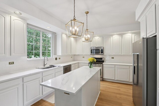 1128 Teasel Ln, Naperville, IL 60564 - kitchen featuring stainless steel appliances, a chandelier, decorative backsplash, white cabinetry, and decorative light fixtures