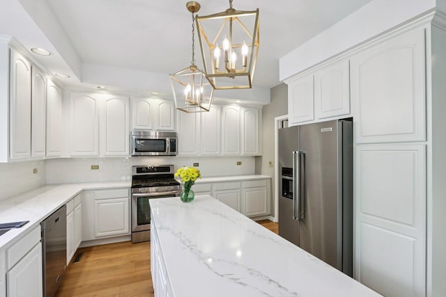 1128 Teasel Ln, Naperville, IL 60564 - kitchen with appliances with stainless steel finishes, a chandelier, white cabinetry, recessed lighting, and light wood-style floors